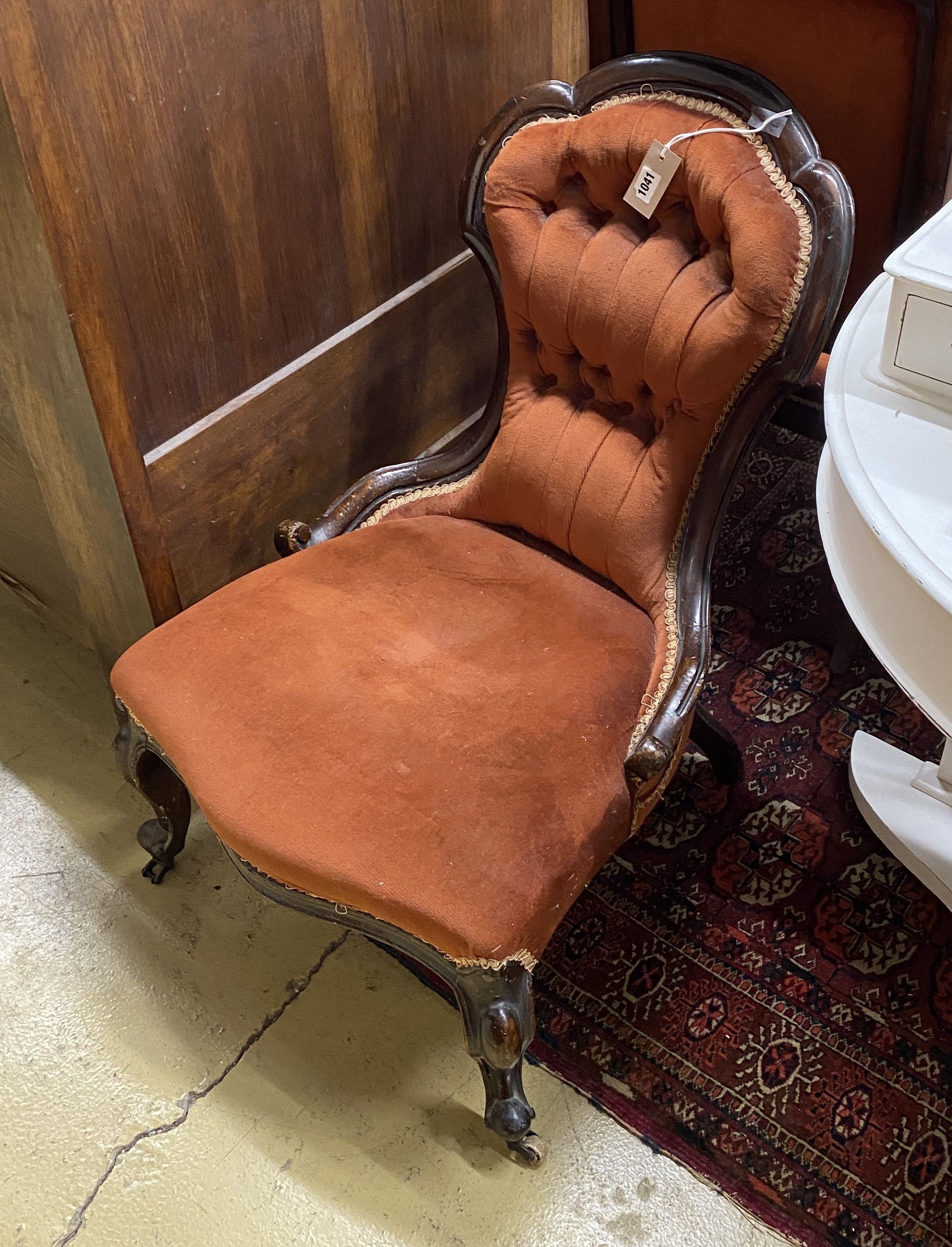 A Victorian carved walnut button back nursing chair